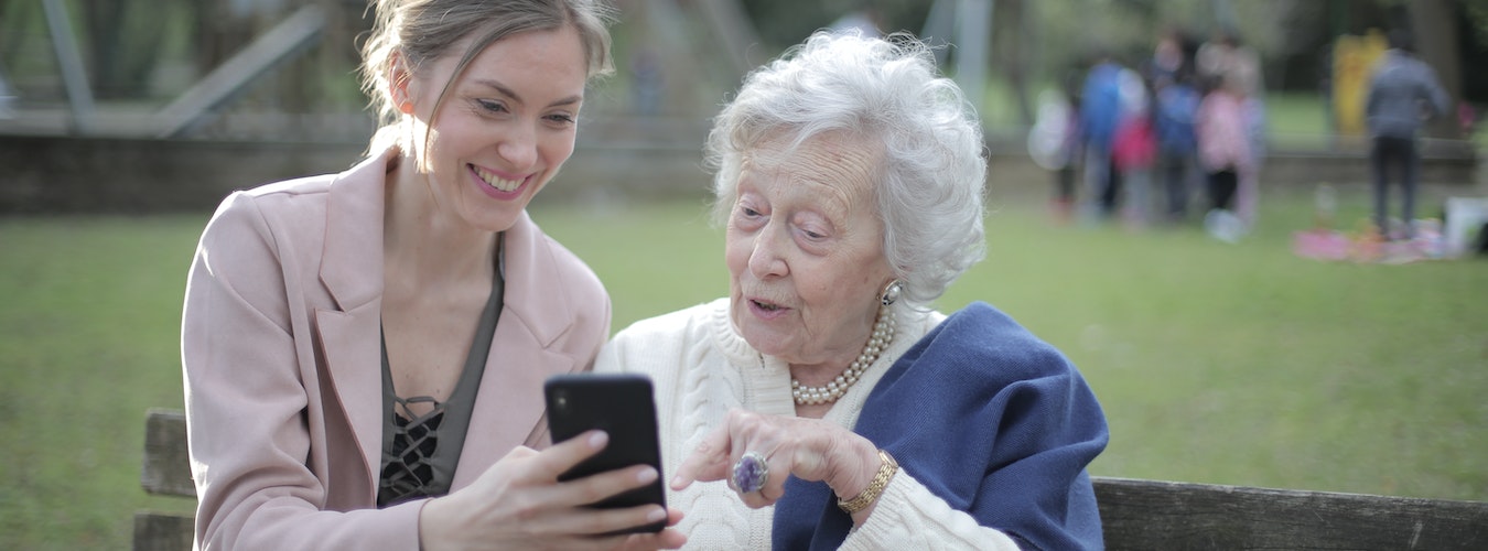 Caregiver supporting an elderly woman